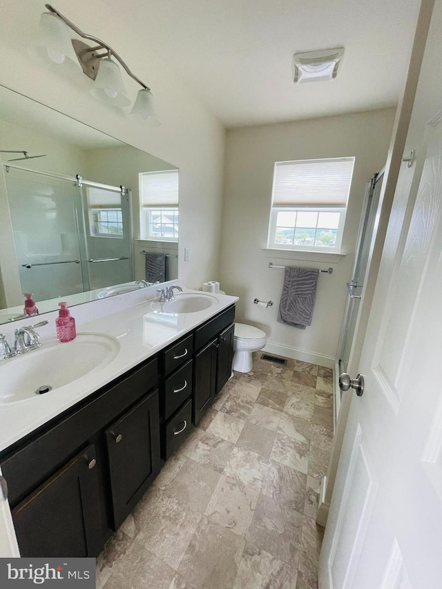 128 Eagle Rd, Dillsburg, PA 17019 - full bathroom featuring a shower stall, double vanity, toilet, and baseboards