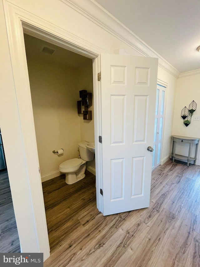 128 Eagle Rd, Dillsburg, PA 17019 - bathroom with crown molding, toilet, wood finished floors, and baseboards