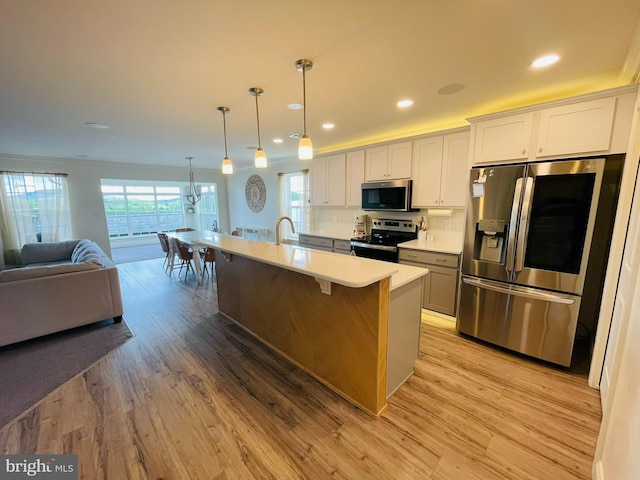 128 Eagle Rd, Dillsburg, PA 17019 - kitchen with appliances with stainless steel finishes, open floor plan, light wood-style floors, light countertops, and recessed lighting