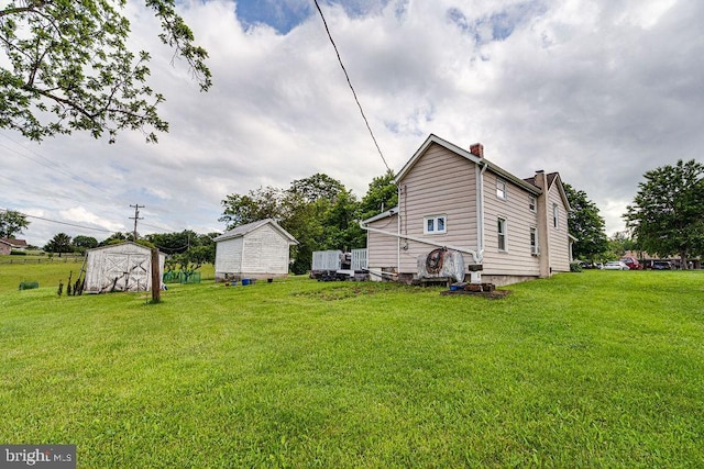 340 Andrews Rd, Strasburg, VA 22657 - view of grassy yard featuring a storage unit and an outbuilding