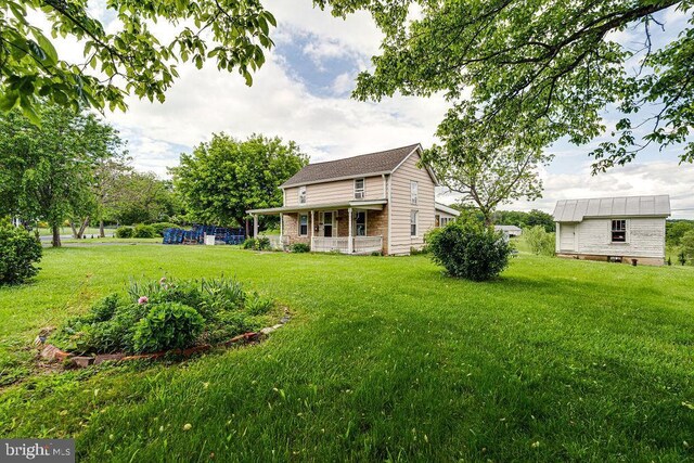 340 Andrews Rd, Strasburg, VA 22657 - view of grassy yard featuring an outdoor structure and a porch