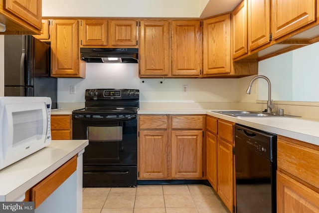 12216 Eagles Nest Ct Unit G, Germantown, MD 20874 - kitchen with black appliances, under cabinet range hood, a sink, and light countertops