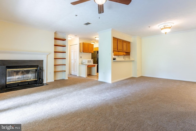 12216 Eagles Nest Ct Unit G, Germantown, MD 20874 - unfurnished living room featuring crown molding, carpet floors, a ceiling fan, a fireplace with flush hearth, and baseboards