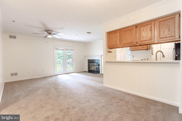 12216 Eagles Nest Ct Unit G, Germantown, MD 20874 - unfurnished living room with ceiling fan, ornamental molding, a fireplace with flush hearth, light colored carpet, and baseboards