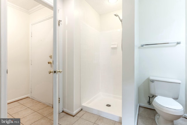 12216 Eagles Nest Ct Unit G, Germantown, MD 20874 - full bathroom featuring a stall shower, toilet, tile patterned flooring, baseboards, and crown molding