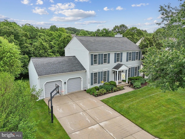 11115 Sceptre Ridge Ter, Germantown, MD 20876 - colonial house featuring a shingled roof, concrete driveway, a front lawn, an attached garage, and a chimney