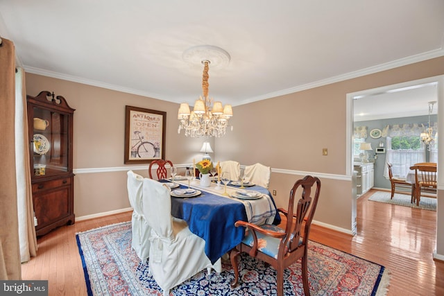 11115 Sceptre Ridge Ter, Germantown, MD 20876 - dining area featuring a chandelier, ornamental molding, and light wood-style floors