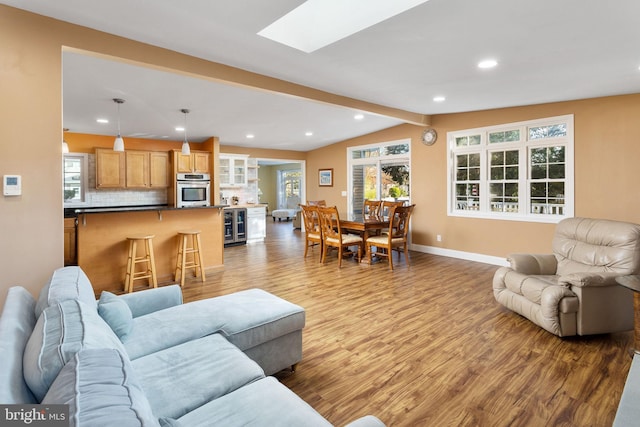 1733 Lockhart St, Toms River, NJ 08757 - living area featuring wood finished floors, baseboards, recessed lighting, a skylight, and beverage cooler