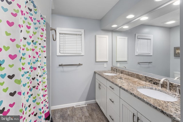 1733 Lockhart St, Toms River, NJ 08757 - full bathroom with wood finished floors, baseboards, recessed lighting, double vanity, and toilet