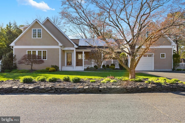 1733 Lockhart St, Toms River, NJ 08757 - view of front facade with a porch, a garage, a front yard, and asphalt driveway