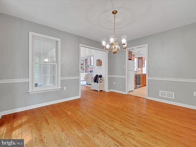 320 N Ridge Rd, Reinholds, PA 17569 - unfurnished room with a chandelier, plenty of natural light, and light wood finished floors
