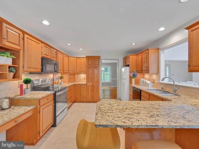 320 N Ridge Rd, Reinholds, PA 17569 - kitchen featuring stainless steel electric range, black microwave, a sink, dishwashing machine, and freestanding refrigerator