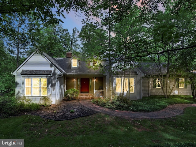 320 N Ridge Rd, Reinholds, PA 17569 - new england style home featuring a porch, a chimney, and a front lawn