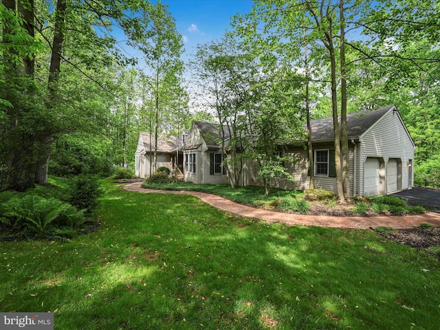320 N Ridge Rd, Reinholds, PA 17569 - back of house with an attached garage, a lawn, and driveway