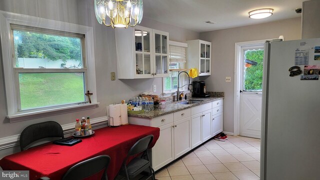 15030 Alabama Ave, Woodbridge, VA 22191 - kitchen with freestanding refrigerator, a sink, healthy amount of natural light, and white cabinets
