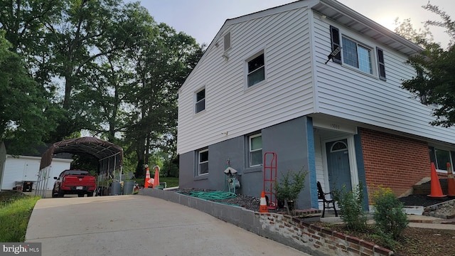 15030 Alabama Ave, Woodbridge, VA 22191 - view of property exterior featuring a carport, concrete driveway, and brick siding