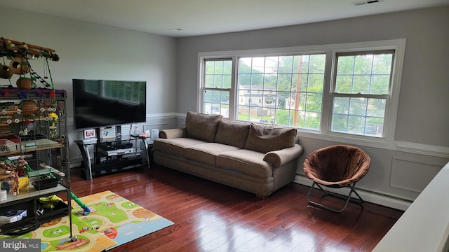 15030 Alabama Ave, Woodbridge, VA 22191 - living area with plenty of natural light, wood finished floors, wainscoting, and a baseboard radiator