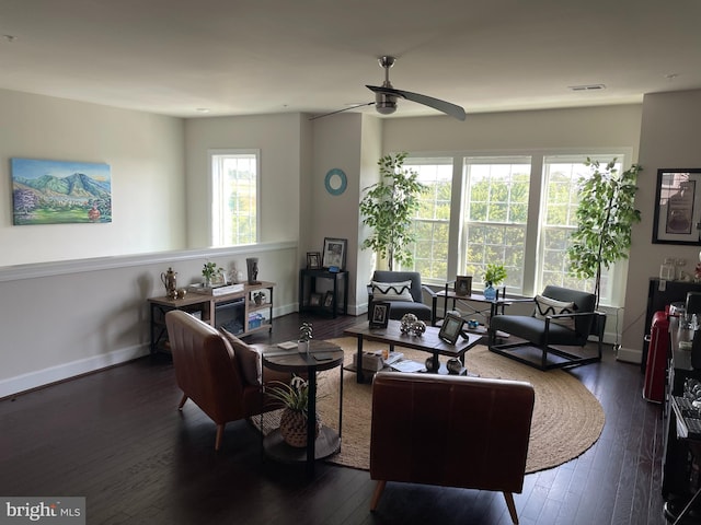 living room with wood-type flooring, ceiling fan, and baseboards