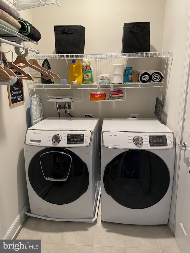 washroom featuring separate washer and dryer and light tile patterned flooring