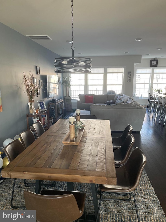 dining space with a chandelier, wood finished floors, and recessed lighting