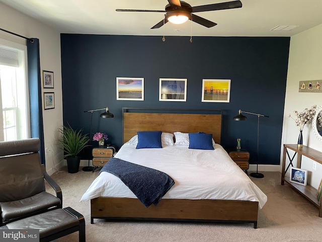 carpeted bedroom with baseboards and ceiling fan