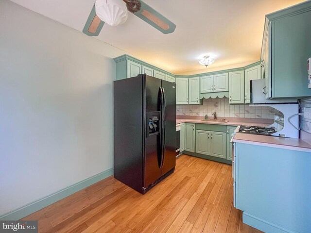 12419 Balston Rd, Philadelphia, PA 19154 - kitchen with black refrigerator with ice dispenser, green cabinets, light countertops, light wood-type flooring, and a ceiling fan