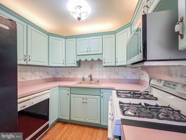 12419 Balston Rd, Philadelphia, PA 19154 - kitchen with white range with gas cooktop, dishwasher, a sink, light wood-style flooring, and decorative backsplash