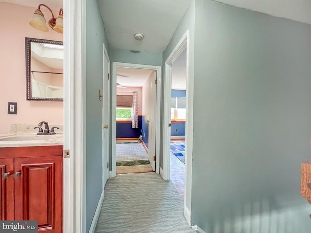 12419 Balston Rd, Philadelphia, PA 19154 - corridor with a sink, light colored carpet, and baseboards
