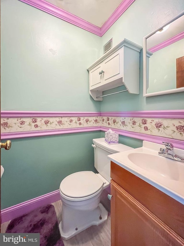 12419 Balston Rd, Philadelphia, PA 19154 - half bathroom featuring vanity, toilet, and ornamental molding