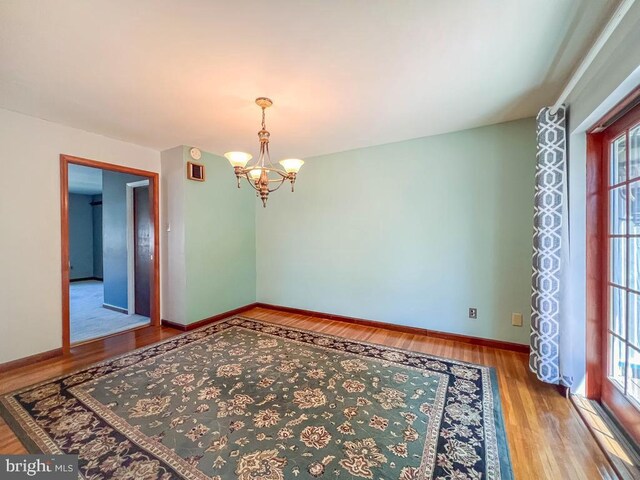 12419 Balston Rd, Philadelphia, PA 19154 - empty room with wood finished floors, a chandelier, and baseboards