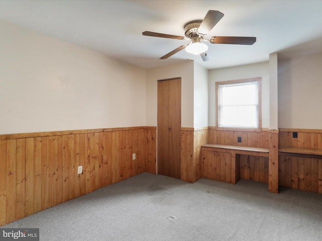 12417 Mount Savage Rd, Mount Savage, MD 21545 - empty room with wainscoting, wood walls, carpet flooring, and ceiling fan