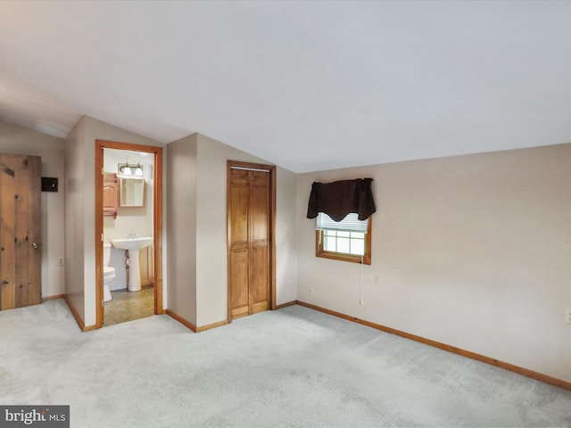 12417 Mount Savage Rd, Mount Savage, MD 21545 - unfurnished bedroom with lofted ceiling, baseboards, light carpet, a sink, and a closet