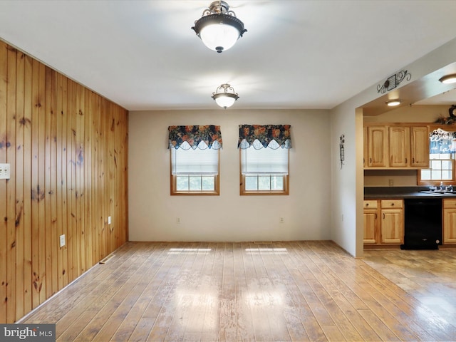 12417 Mount Savage Rd, Mount Savage, MD 21545 - unfurnished dining area featuring light wood-style flooring, wooden walls, and a sink