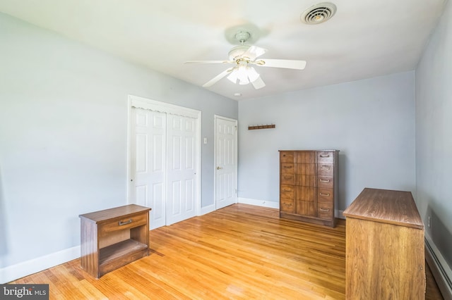 1143 Villanova Ave, Swarthmore, PA 19081 - unfurnished bedroom featuring light wood finished floors, a baseboard heating unit, a closet, and baseboards