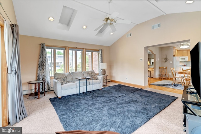 1143 Villanova Ave, Swarthmore, PA 19081 - living room featuring lofted ceiling, ceiling fan, arched walkways, baseboards, and carpet