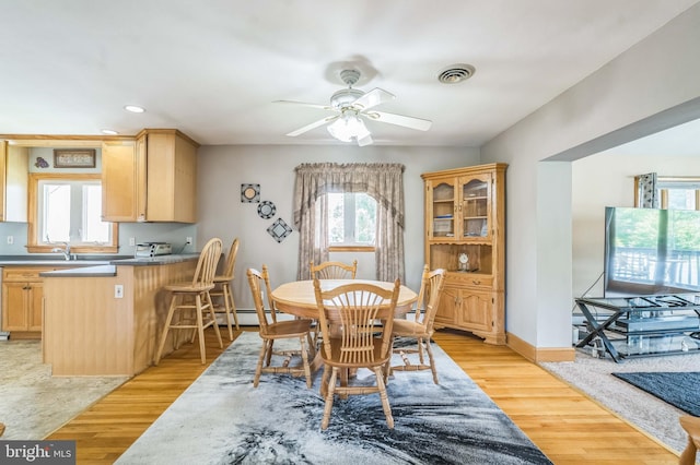 1143 Villanova Ave, Swarthmore, PA 19081 - dining area with a baseboard radiator, a ceiling fan, light wood-style flooring, recessed lighting, and baseboards