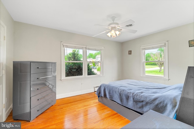 1143 Villanova Ave, Swarthmore, PA 19081 - bedroom featuring light wood-style floors, baseboards, ceiling fan, and a baseboard heating unit