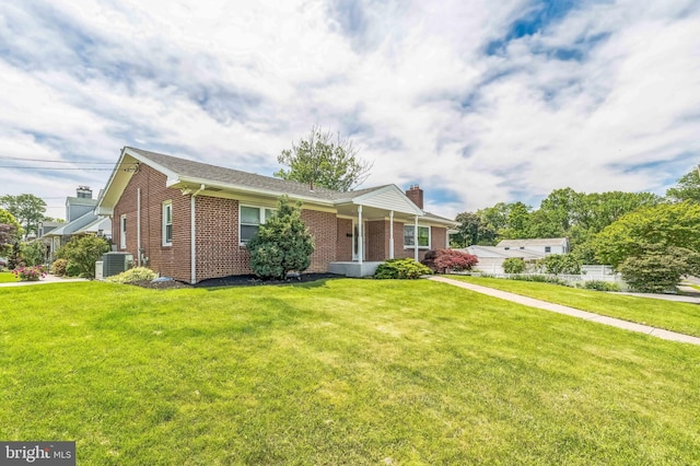 1143 Villanova Ave, Swarthmore, PA 19081 - view of front facade with central AC unit, brick siding, and a front lawn