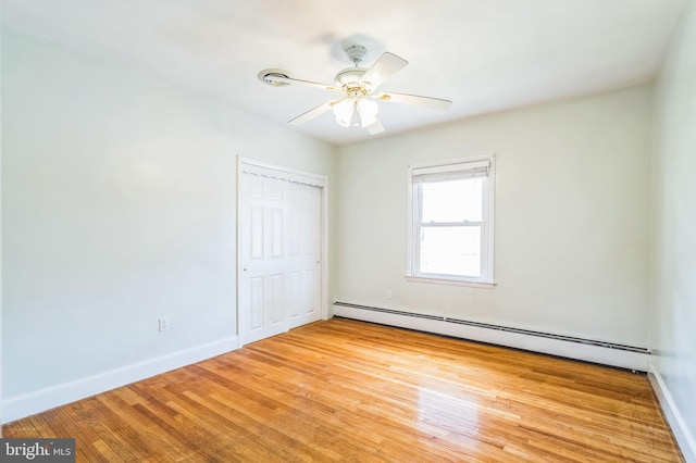1143 Villanova Ave, Swarthmore, PA 19081 - unfurnished bedroom with a baseboard heating unit, a closet, baseboards, light wood-style flooring, and ceiling fan