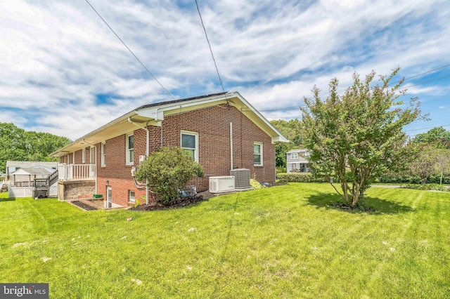 1143 Villanova Ave, Swarthmore, PA 19081 - view of home's exterior with brick siding, central air condition unit, and a lawn
