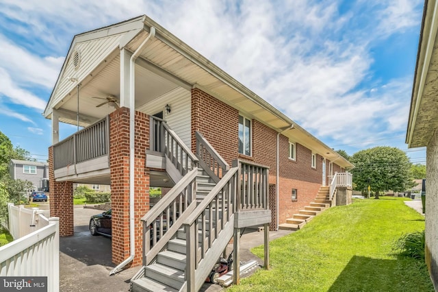 1143 Villanova Ave, Swarthmore, PA 19081 - view of side of home featuring stairway, brick siding, ceiling fan, and a yard