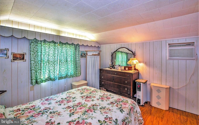 136 Camp Meeting Cir, Herndon, PA 17830 - bedroom with wood finished floors, a wall mounted AC, and wooden walls