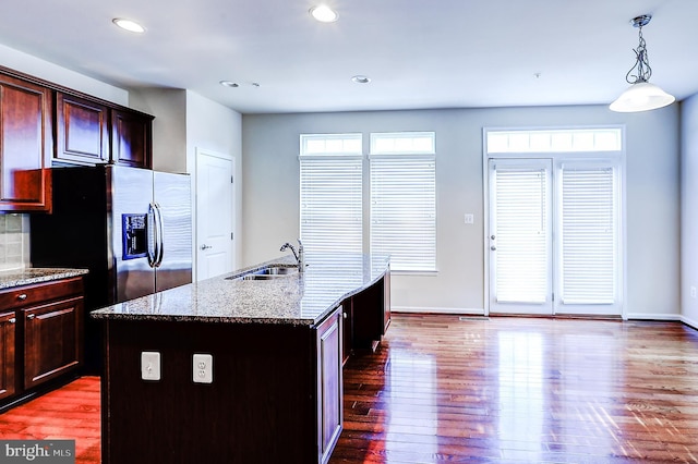 6300 Santo Pl, Capitol Heights, MD 20743 - kitchen with a sink, dark wood-style floors, light stone counters, baseboards, and pendant lighting