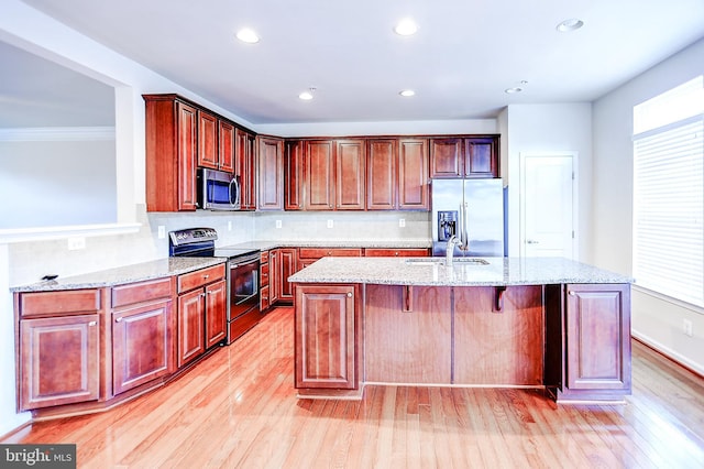 6300 Santo Pl, Capitol Heights, MD 20743 - kitchen with stainless steel appliances, light wood-style floors, a sink, a kitchen island with sink, and recessed lighting