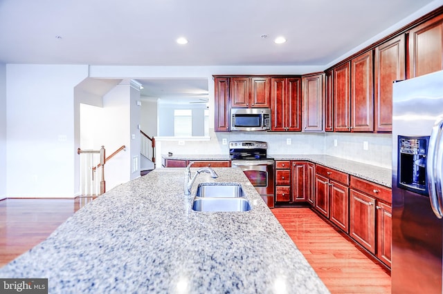 6300 Santo Pl, Capitol Heights, MD 20743 - kitchen with stainless steel appliances, a sink, dark brown cabinets, light wood-style floors, and recessed lighting