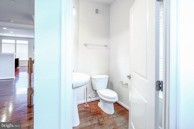 6300 Santo Pl, Capitol Heights, MD 20743 - bathroom with wood finished floors, toilet, and baseboards
