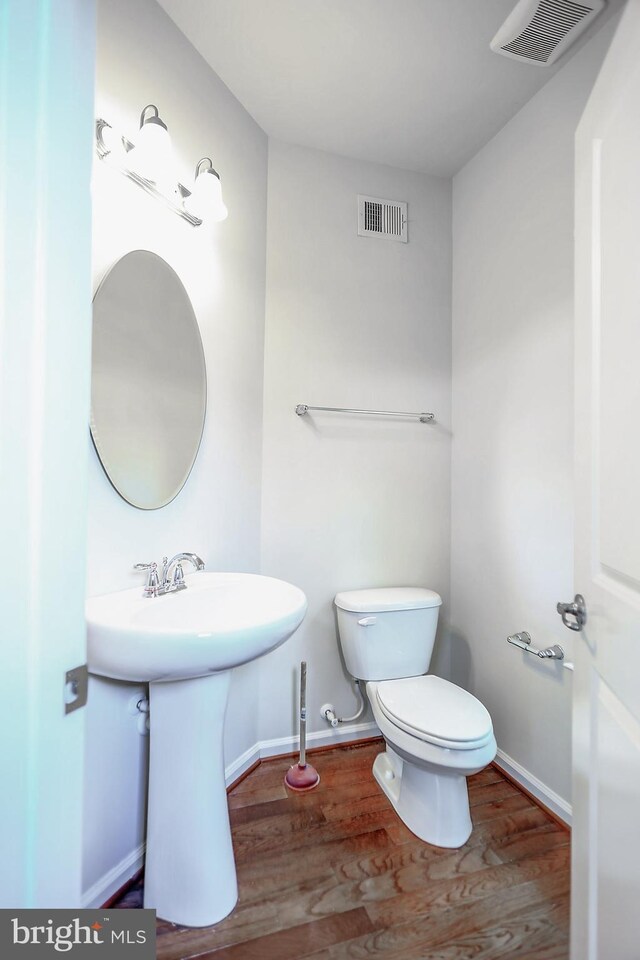 6300 Santo Pl, Capitol Heights, MD 20743 - half bath with wood finished floors, toilet, baseboards, and a sink