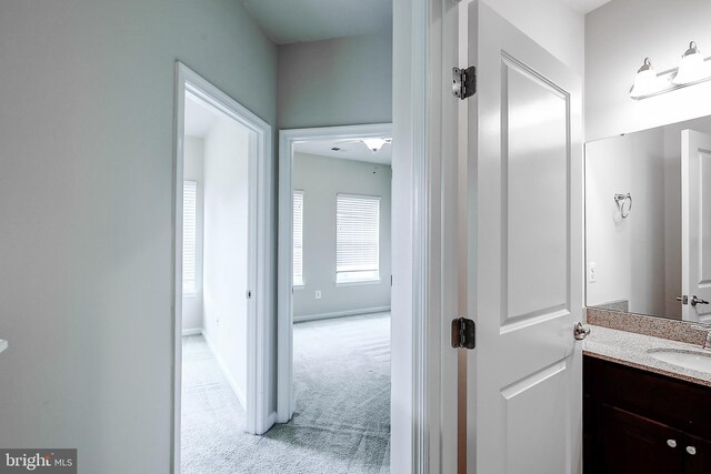 6300 Santo Pl, Capitol Heights, MD 20743 - hallway with light colored carpet and a sink