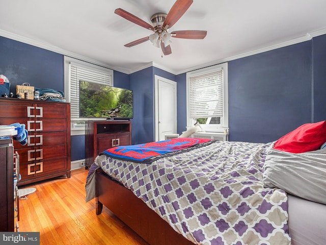 bedroom with light wood-style floors, ornamental molding, and ceiling fan