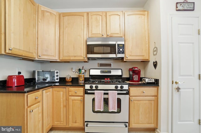 1009 Samantha Ln Unit 302, Odenton, MD 21113 - kitchen featuring appliances with stainless steel finishes, light brown cabinetry, and dark countertops